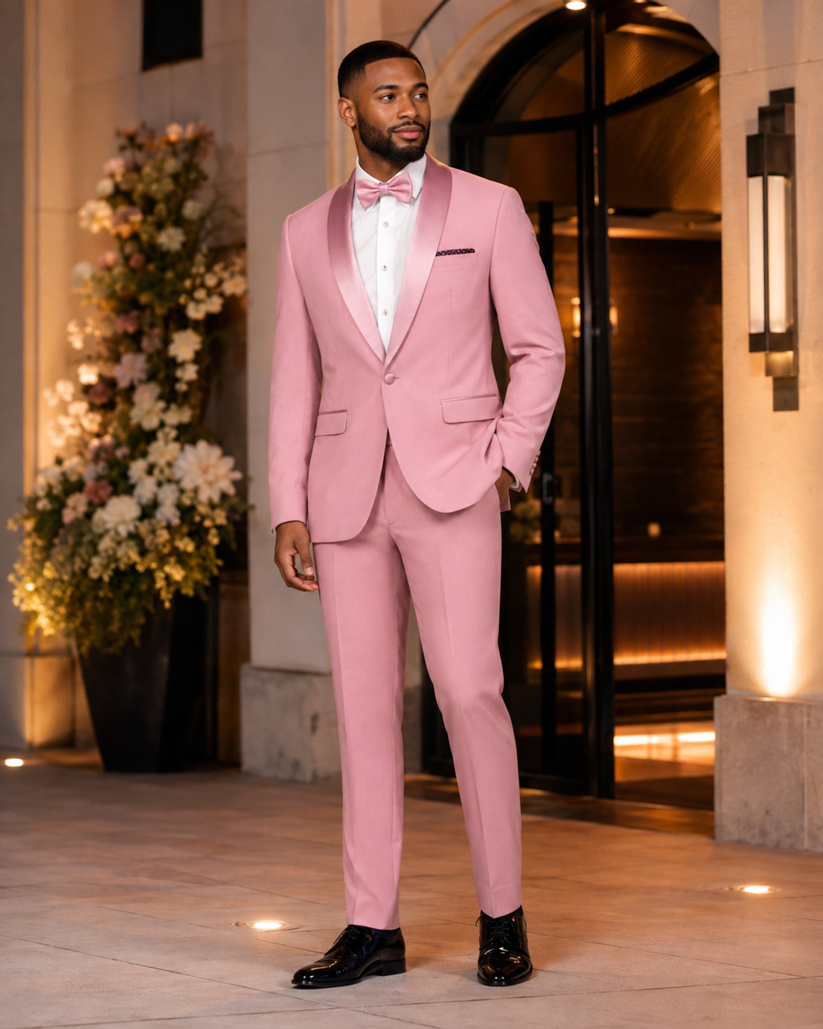 Man wearing the Dusty Rose Aurelio slim fit tuxedo at an elegant wedding venue
