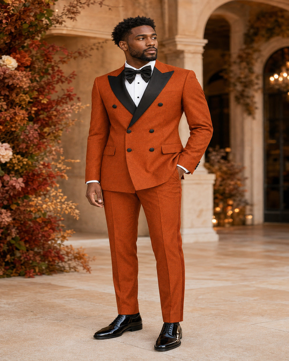 Man wearing Rust Castello double-breasted tuxedo in an elegant formal setting