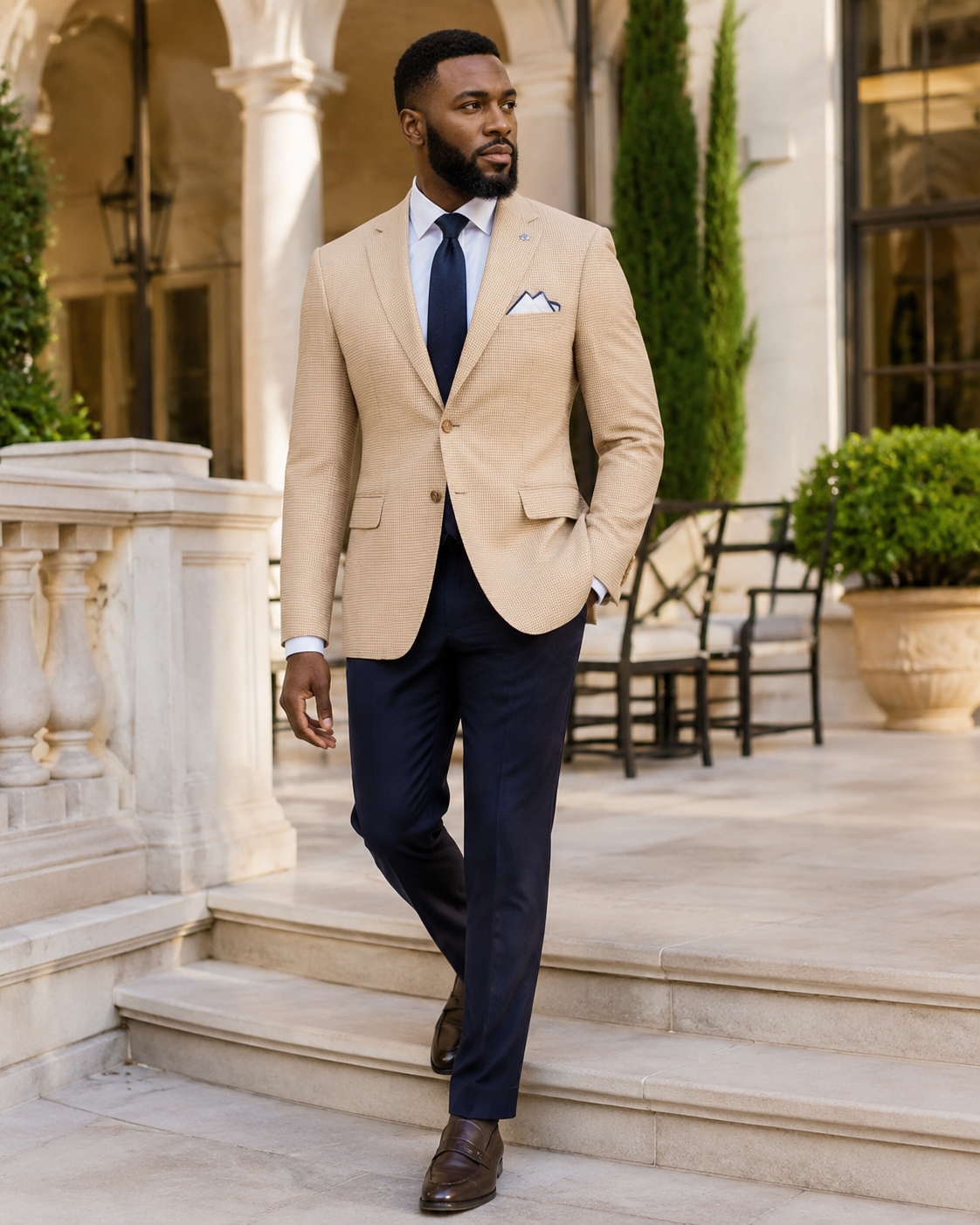 Man wearing tan houndstooth blazer with navy tie