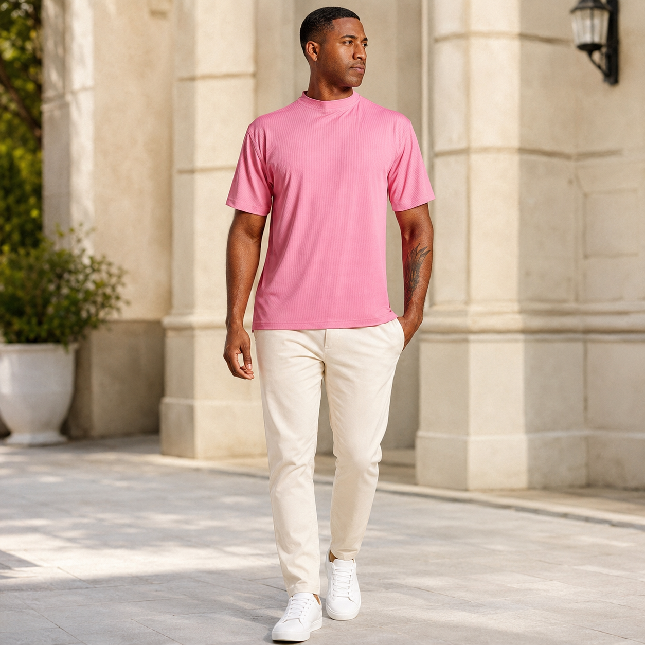 Men's summer pink ribbed crew neck T-shirt styled with cream pants outdoors
