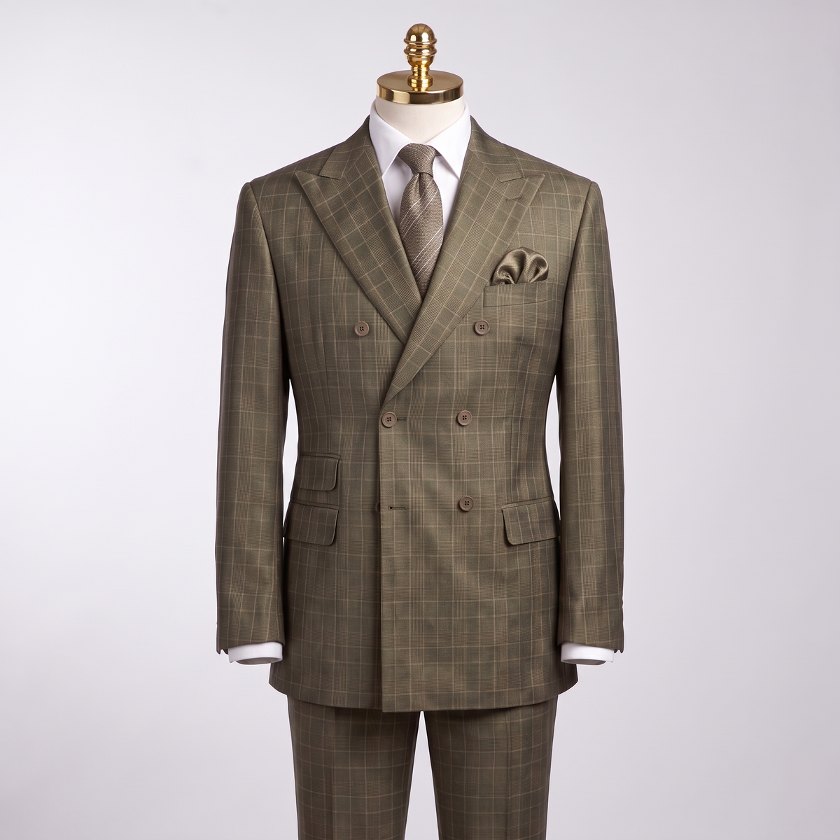 Olive glen plaid double-breasted suit on gold-top mannequin with matching trousers partially visible