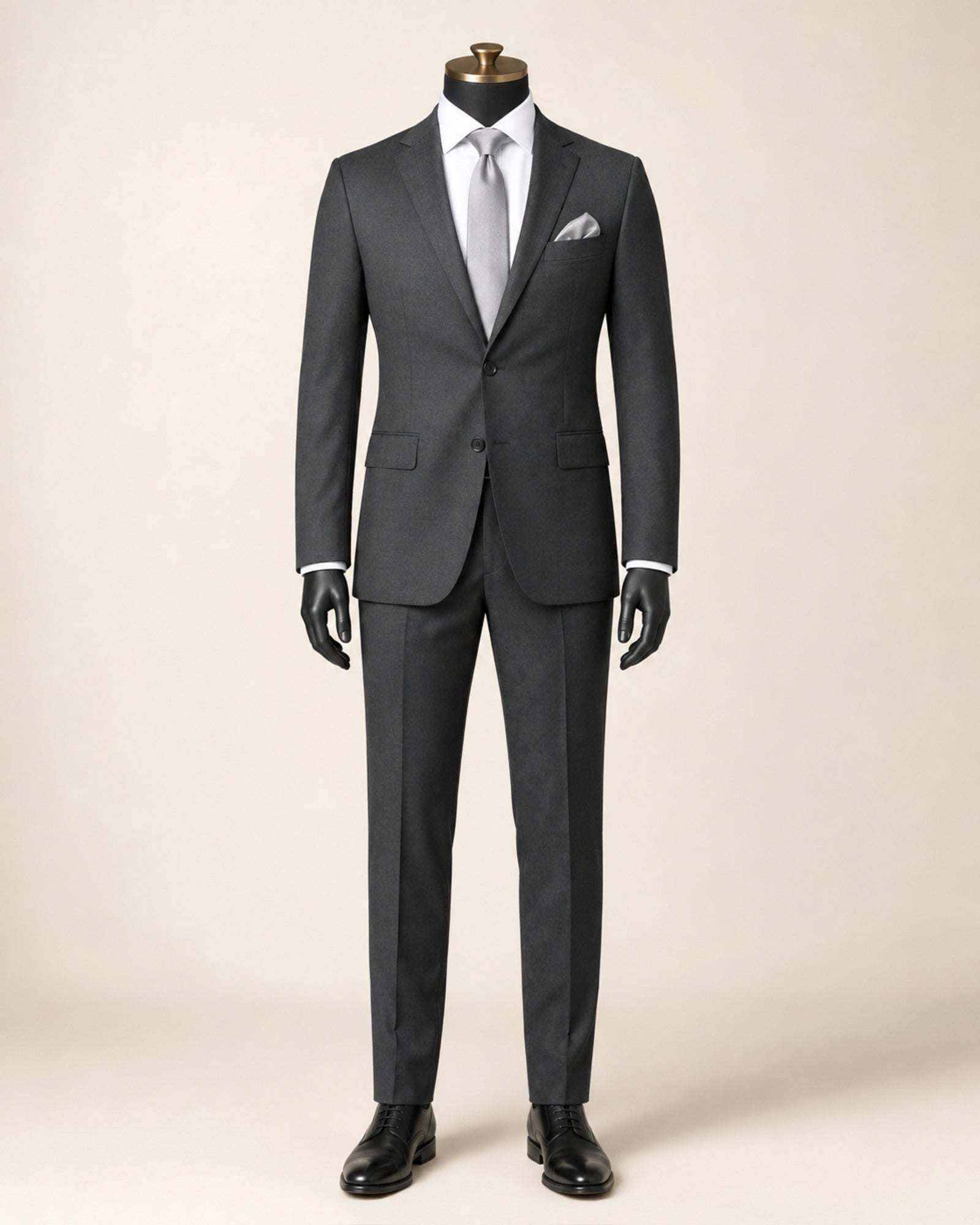 Men's charcoal slim fit stretch two-piece suit on black mannequin with gold top